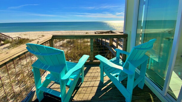 A balcony with two turquoise chairs facing a beach. - Beachfront in Surfside Shores (Gulf Shores)