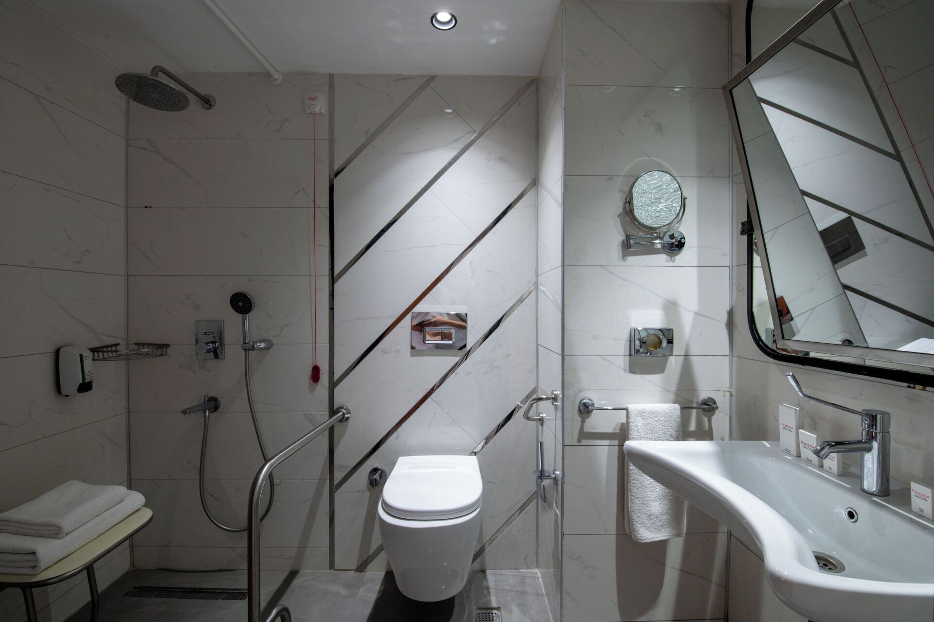 A modern bathroom with a toilet, bidet, and shower.