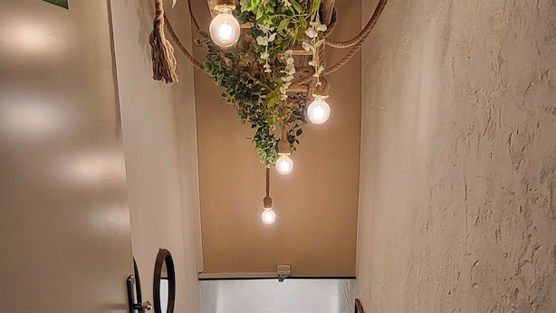 A staircase with a rustic design, including a rope light fixture and potted plants. - Gutshof Elbschloss Kehnert (Tangerhütte)