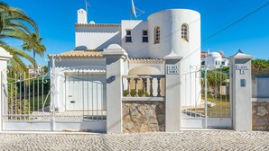 A white building with a gated entrance, a satellite dish, and a sign reading "CASA NORA". - Villa Noras - Three Bedroom Villa, Sleeps 6 (Albufeira)