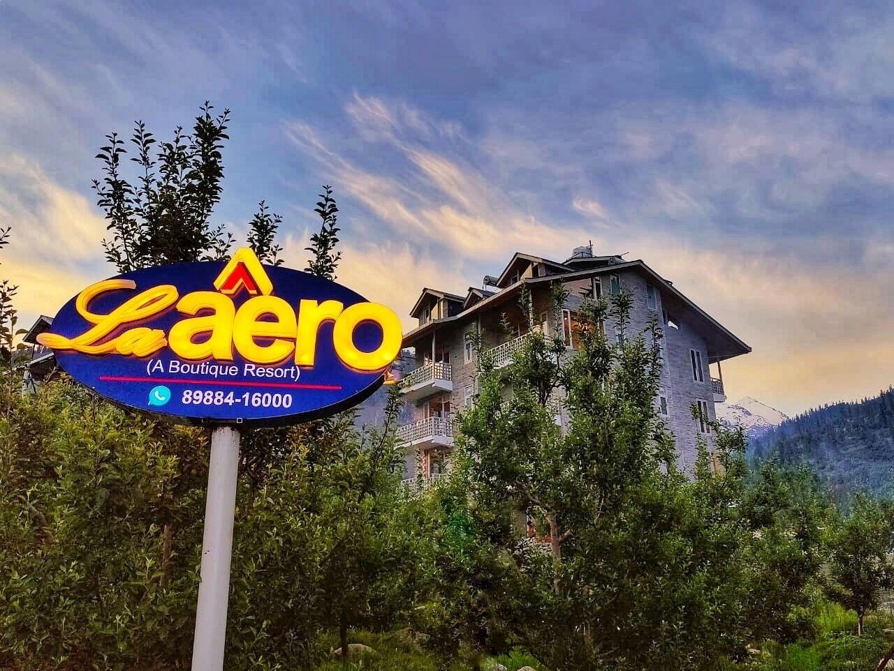 A sign for La Aero Boutique Resort with a mountain backdrop.