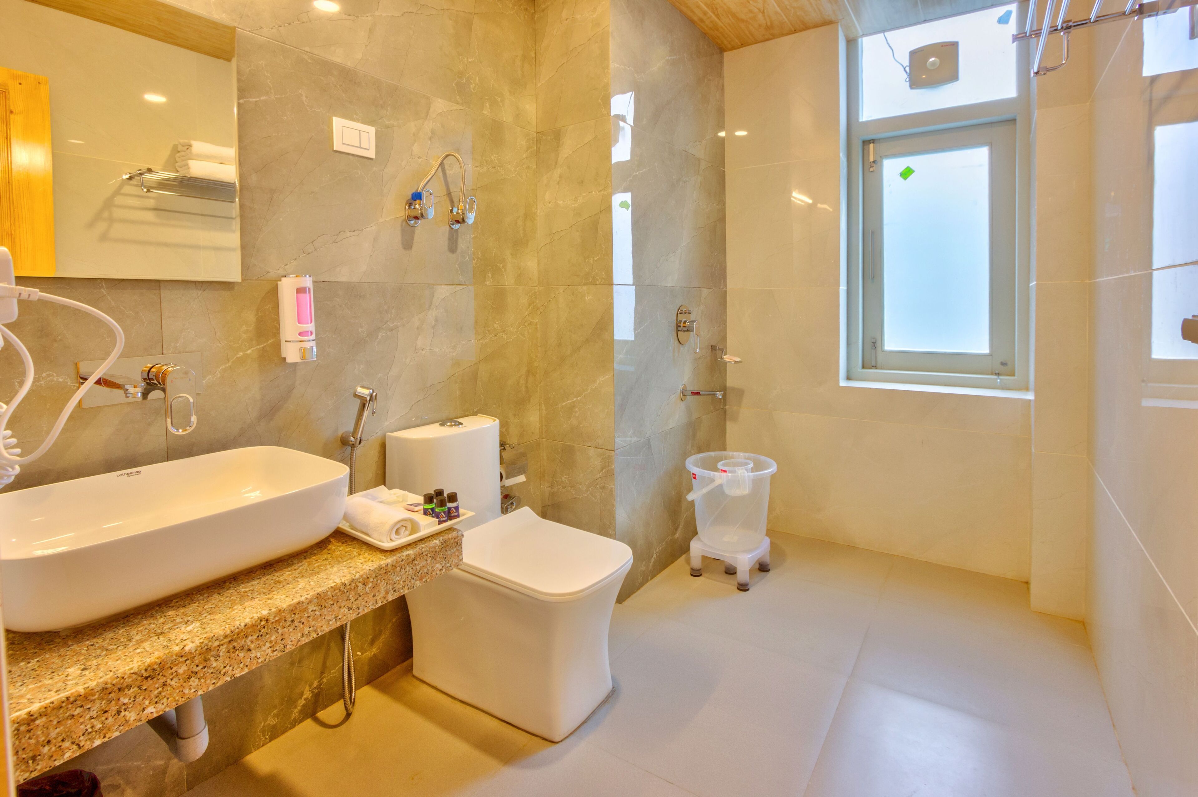 A modern bathroom with a large sink, toilet, and shower area.
