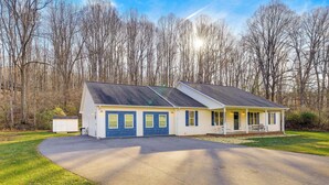 A single-story house with a garage, a covered porch, and a driveway. - Virginia Escape w/ Patio & Fire Pit, Near Hiking! (Speedwell)