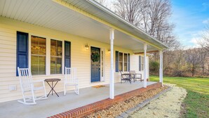 A house with a porch, white rocking chairs, a table, and a brick border. - Virginia Escape w/ Patio & Fire Pit, Near Hiking! (Speedwell)
