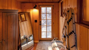 A wooden interior with a door, a mirror, a rug, and a blanket. - 3 Mi to Big Bear Village: Charming Sugarloaf Cabin (Sugarloaf)