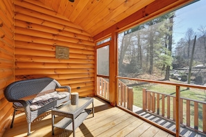 A log cabin with a wooden deck, a bench, and a table. - On-site Waterfall! Cabin Near Blue Ridge Pkwy (Ennice)