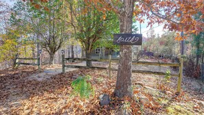 A park with a sign reading "faith" and a wooden fence. - 'faith Cabin' in Cosby: Fire Pit + Covered Deck (Cosby)