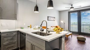 Fully stocked kitchen with dishwasher and deep farmhouse sink. 