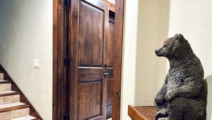 A wooden door with a bear statue on a shelf. - Ski-In/Out 5 BR House at Copper Mtn (Frisco)