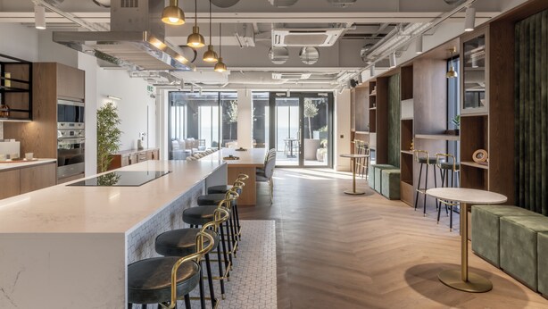 A modern kitchen with a central island, bar stools, and pendant lighting. - Croydon by Charles Hope (Croydon)
