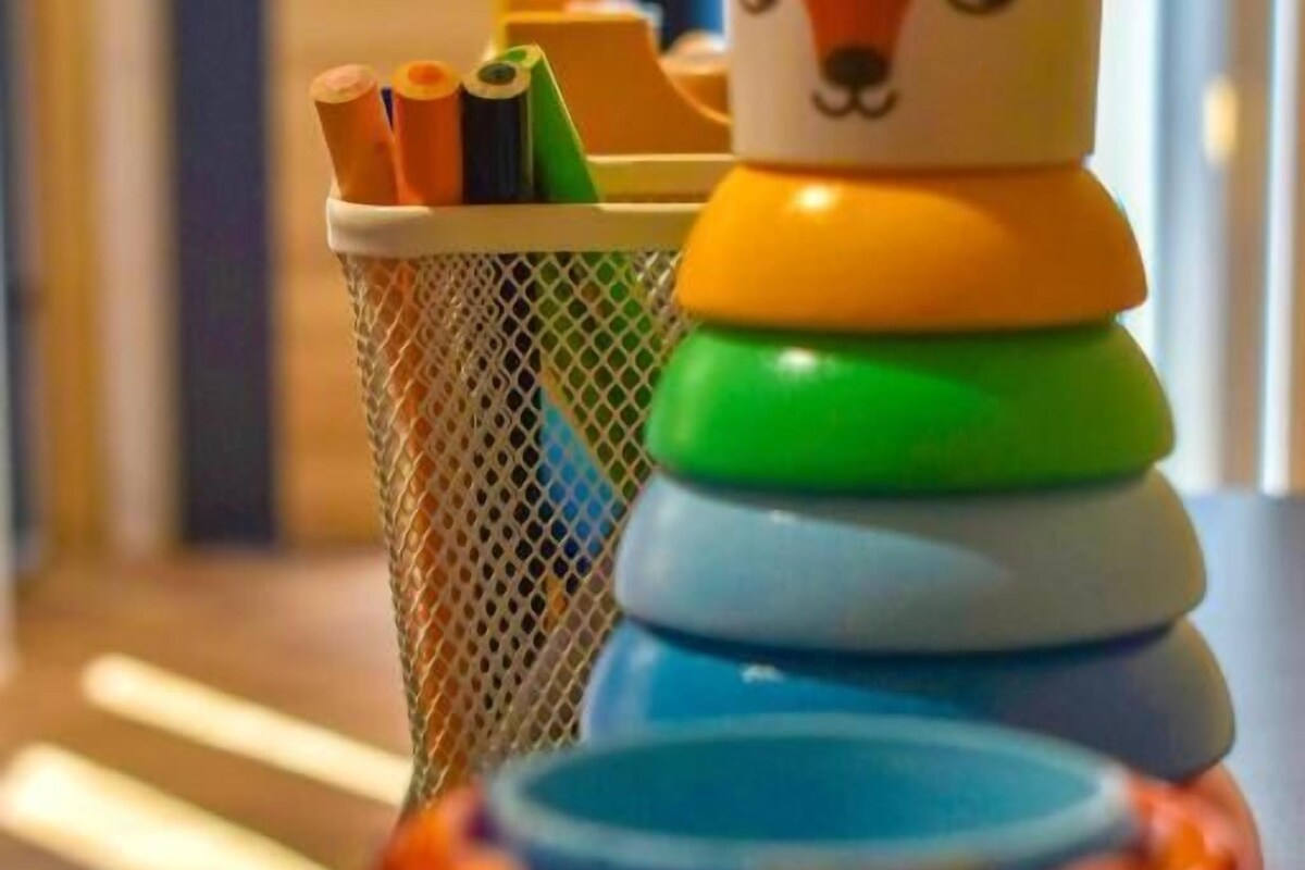 Ein Spielzeugfuchs und farbenfrohe Ringe auf einem Tisch.