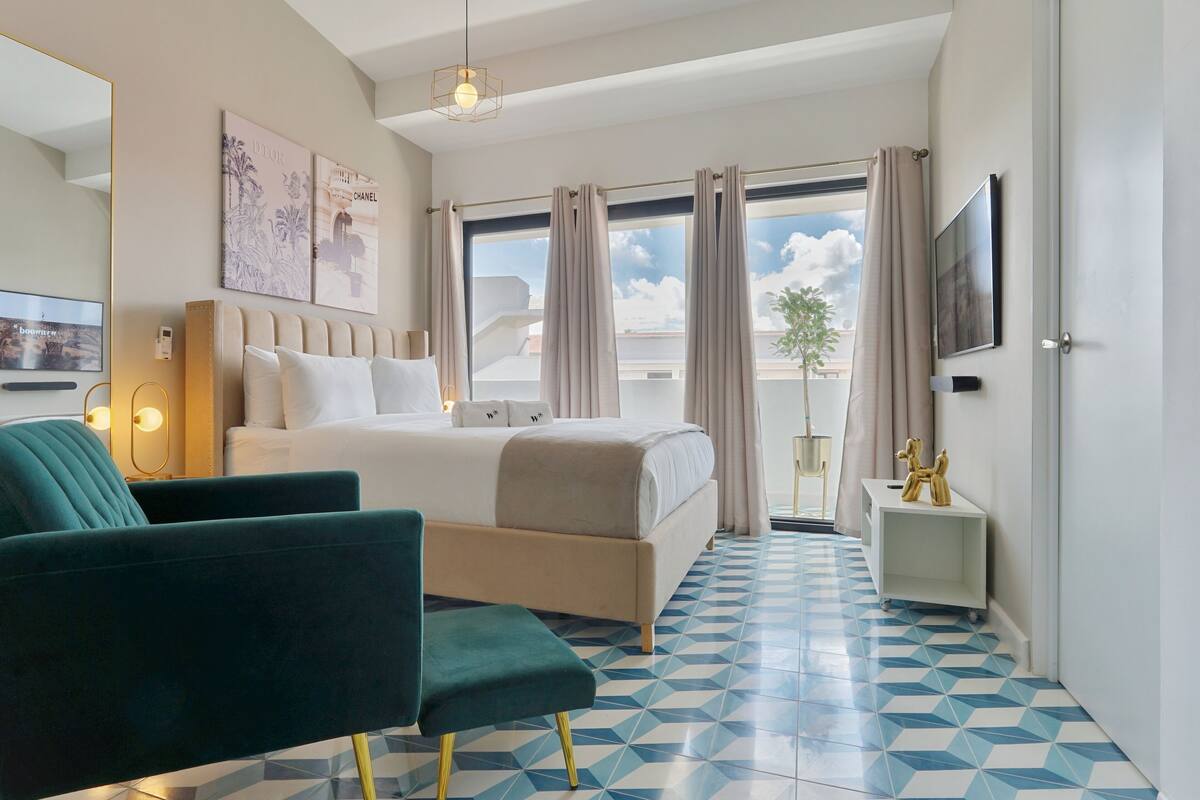 Ein Hotelzimmer mit Bett, Fernseher, Schreibtisch und Stuhl.