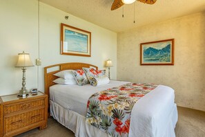 A bedroom with a bed, two bedside tables, and two wall-mounted lamps.