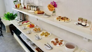 A buffet setup with various food items and condiments on shelves.