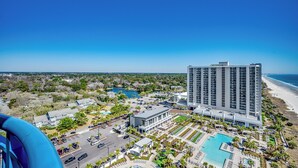 A high-rise hotel with a pool and beach view. - Ocean Front Crown New Remodel (MYRTLE BEACH)