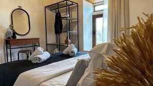 A neatly arranged bedroom with a bed, a dresser, a mirror, and a wardrobe. - Afroditi,2 bedrooms,pool,Margarites,Rethymno,Crete (Pigouniana)