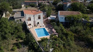 An aerial view of a villa with a swimming pool, surrounded by trees and other buildings. - Afroditi,2 bedrooms,pool,Margarites,Rethymno,Crete (Pigouniana)