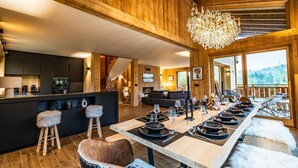 Une cuisine moderne dotée d’un îlot central, de planchers en bois et d’un lustre.