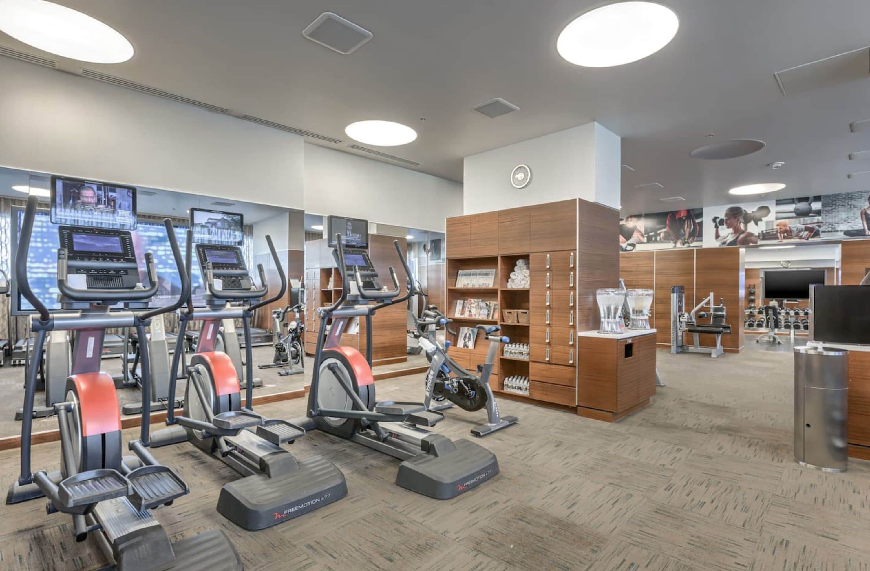 A gym with treadmills, ellipticals, and weight machines.