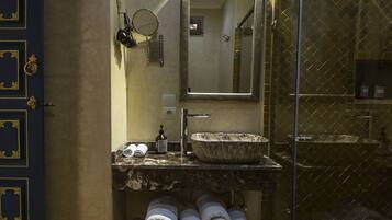 A bathroom with a sink, mirror, and towel rack.