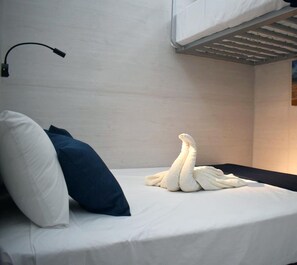 Relax in a serene space with a comfortable bed, crisp linens, and a cozy throw.