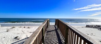 Beach-view cottage near beach with pool, wrap-around balcony, boat dock, W/D, AC