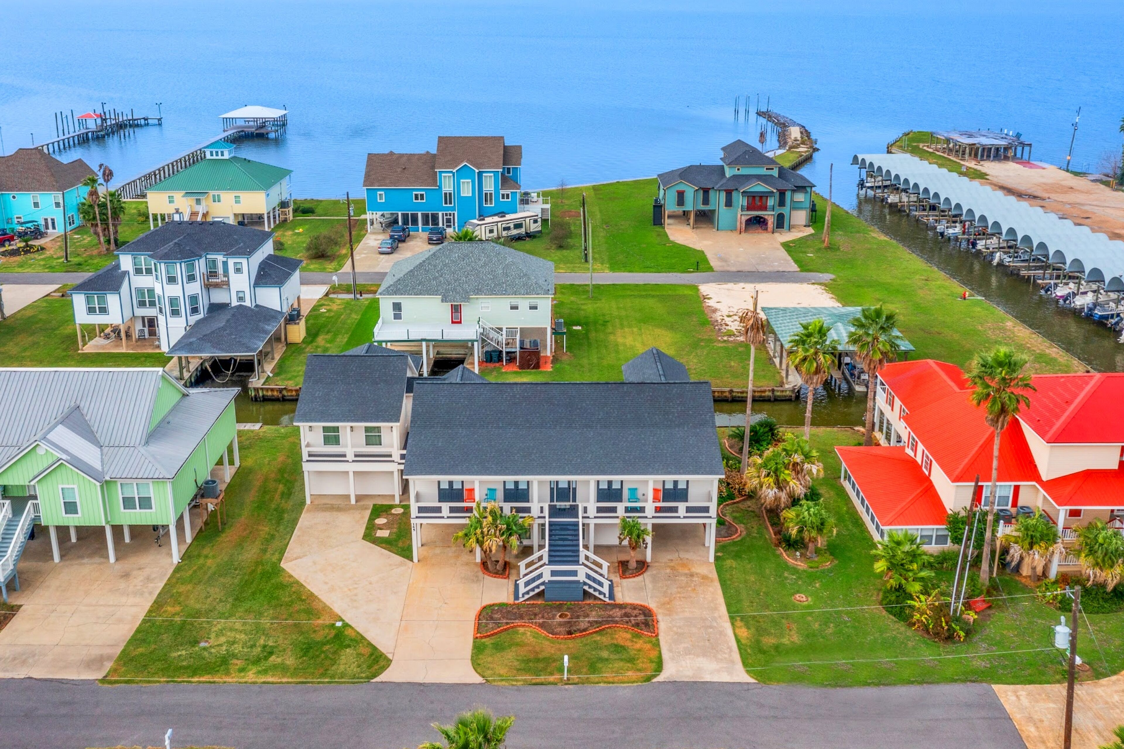 Modern waterfront home with boat lift, dock, game tables, kayak, & AC