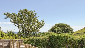 A wooden deck with a view of the sea and hills. - 3 bedroom accommodation in Gorran Haven (Gorran Haven)