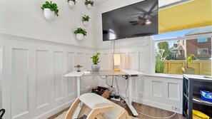 Enjoy a comfortable stay with a flat-screen TV, ceiling fan, and desk, plus a view of the outside from the window.