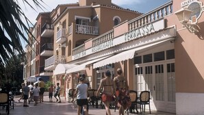 A street with a restaurant named 'Terrassia' and a sign for 'Apartments'.
