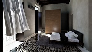 A modern bedroom with a geometric patterned floor, a bed with white linens, a wooden panel wall, and a hanging curtain. - San Patricio Hotel Boutique (Mérida)