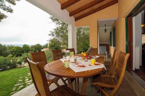 Enjoy al fresco dining amidst lush gardens and a serene landscape.