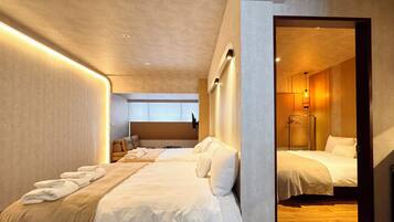 A modern hotel room with a large bed, a seating area, and a mirror reflecting the room.