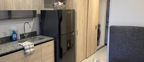 Fridge, microwave, coffee/tea maker, cookware/dishes/utensils