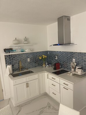 Fridge, stovetop, coffee/tea maker, cookware/dishes/utensils