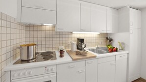 A modern kitchen with white cabinetry, a stove, a coffee maker, and a sink.