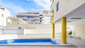 A modern building with a swimming pool, balconies, and a clear sky. - Torre del Rey by Interhome (Oropesa del Mar)