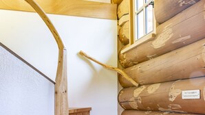 A wooden staircase with a handrail, a window, and a sign with text. - Holiday Home 'Blockhaus Almhütte Wiesenglück' with Private Terrace, Private Garden and Wi-Fi (Glatten)
