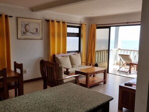 Elite Apartment | Living area | 34-inch LED TV with digital channels, books