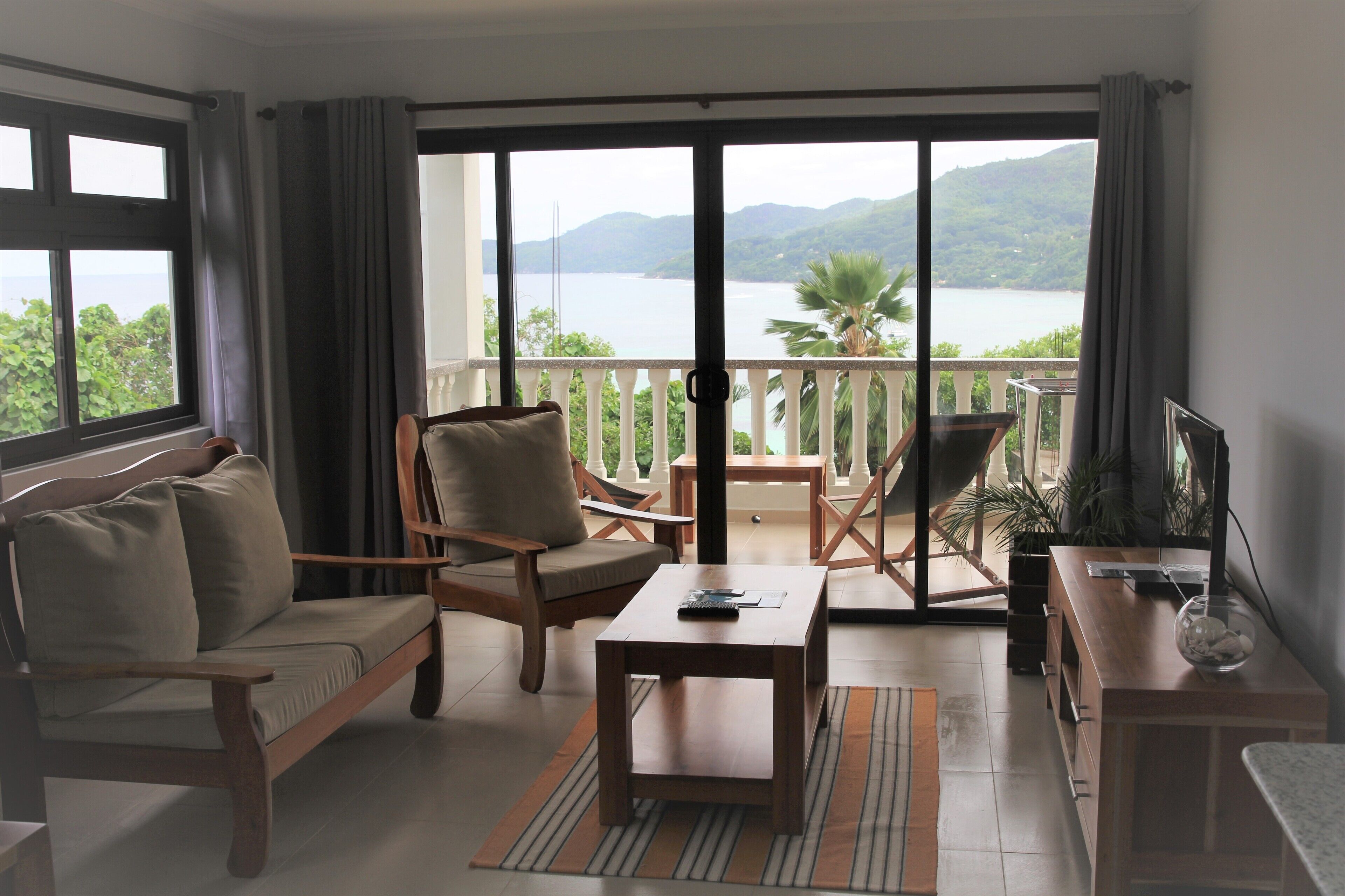 Luxury Apartment | Living area | 34-inch LED TV with digital channels, books