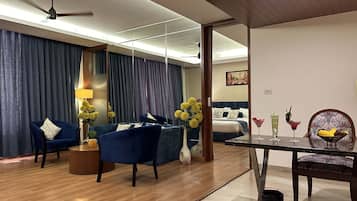 Luxury Suite | Living area | 52-inch flat-screen TV with cable channels