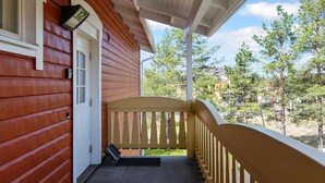 A wooden house with a porch and a door. - Outapailakka j 12 by Interhome (Inari)