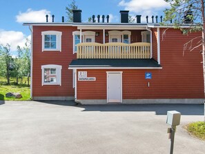 A red building with a balcony, a mailbox, and a door labeled 'OTAPAILAKKA'. - Outapailakka j 12 by Interhome (Inari)