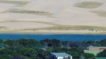 Enjoy breathtaking ocean views from this coastal property surrounded by lush greenery and trees.
