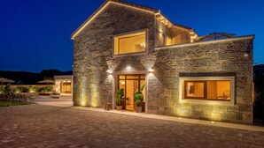 A two-story stone building with a large entrance and a second-floor balcony. - Gorgeous home in Cera with WiFi (Cera)