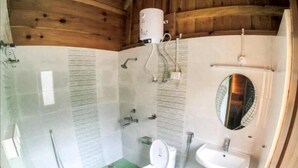 Un baño pequeño con inodoro, lavamanos y ducha.