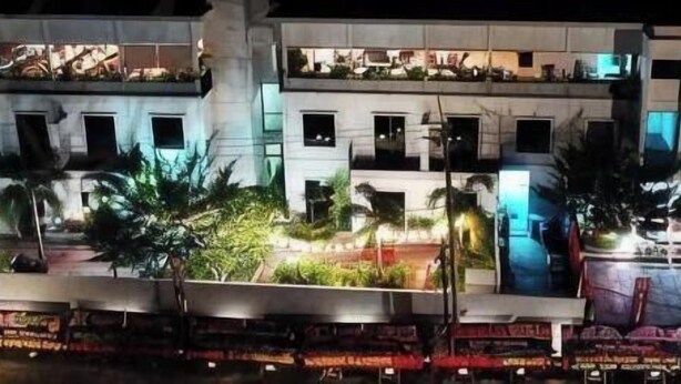 A multi-story hotel with balconies, a swimming pool, and a covered outdoor area. - Onyx Hotel & Villa (Bintan)