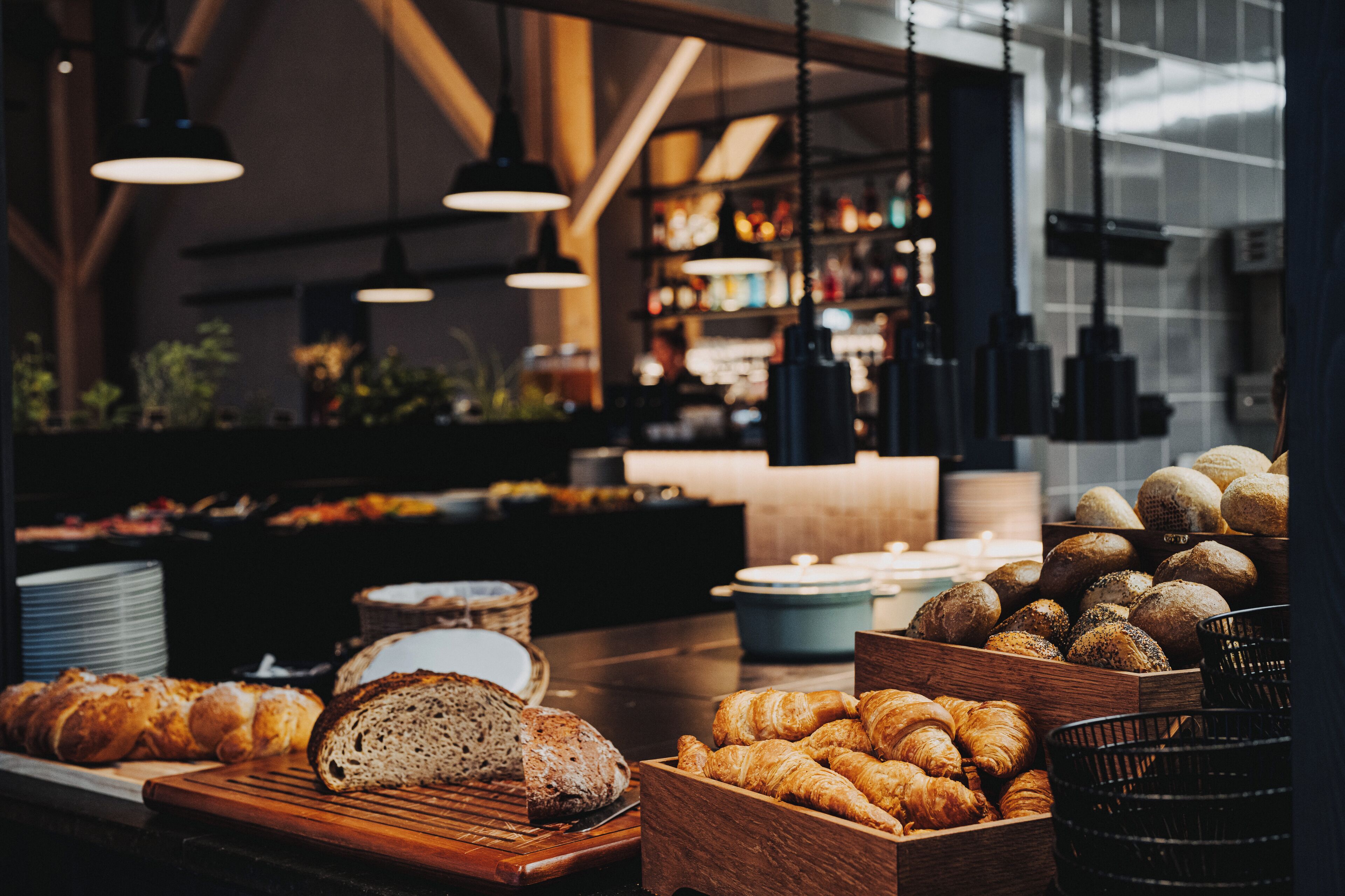 A bakery display with various breads and pastries.
