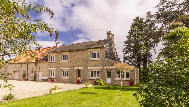 A stone house with a tiled roof, multiple windows, and a well-maintained lawn. - Charming house in Normandy, pets allowed, parking (Hautteville-Bocage)