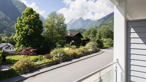 A residential area with a road, houses, and mountains in the background. - Der Gletscherblick by Alpin Rentals - incl Summercard  (Kaprun)